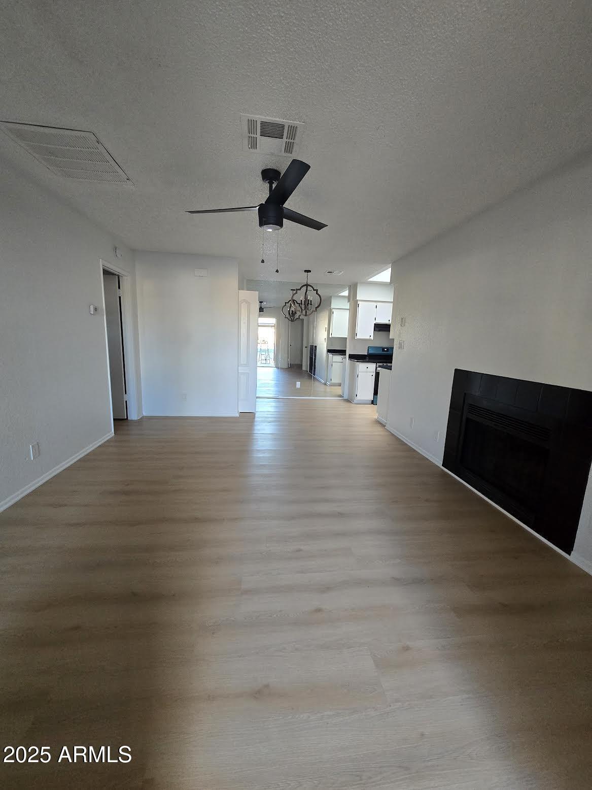 97 North Cooper Road, Unit 86 Chandler, AZ 85225 - Photo 3 of 16 a view of a livingroom with a kitchen and a stove top oven