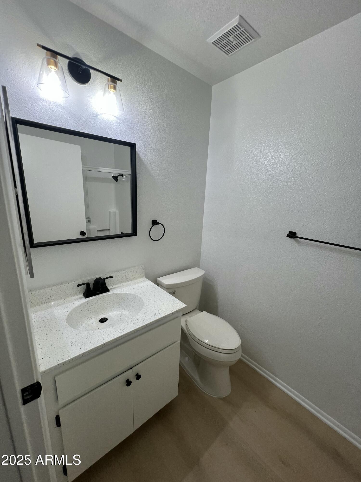97 North Cooper Road, Unit 86 Chandler, AZ 85225 - Photo 8 of 16 a bathroom with a toilet sink and mirror