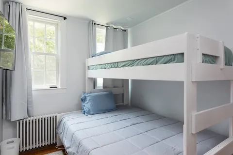 a bedroom with a bed and a tv