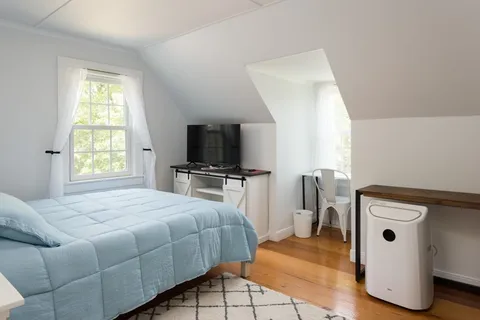 a bedroom with a bed and a window