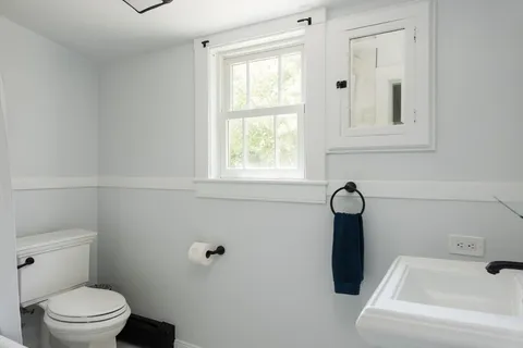 a bedroom with a bed and a mirror