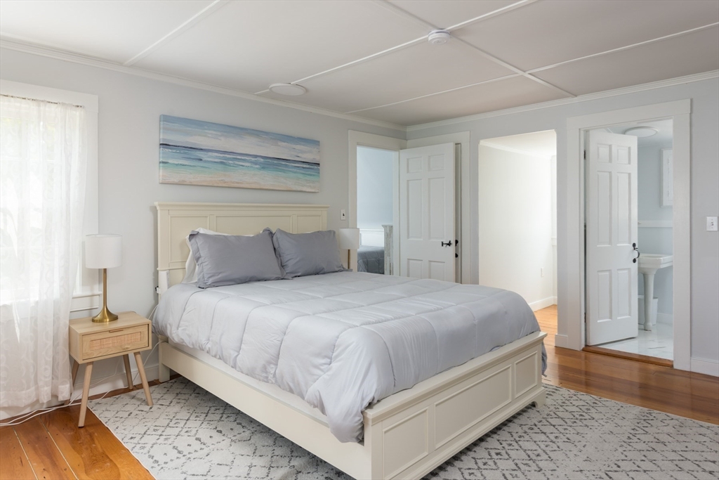 16 Jefferson Shores Road Wareham, MA 02532 - Photo 29 of 35 a bedroom with a bed and wooden floor