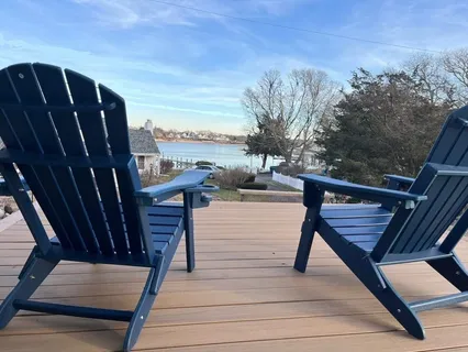 a view of a house with backyard and sitting area