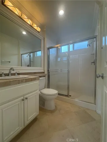 a bathroom with a double vanity sink toilet and shower