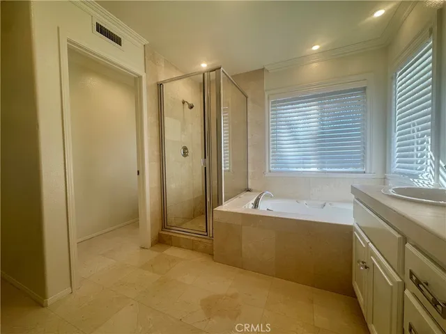 a bathroom with a tub sink shower and a mirror