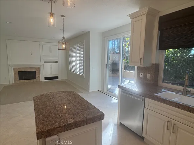 a kitchen with stainless steel appliances granite countertop a sink and a refrigerator