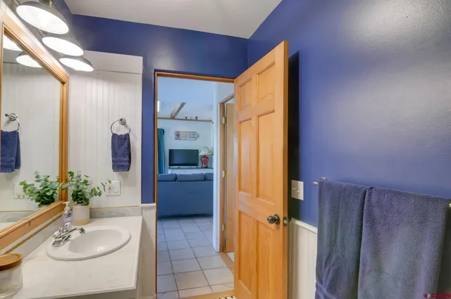 a bathroom with a tub sink and mirror