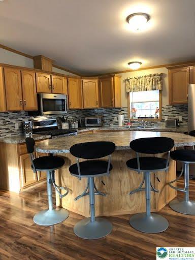 4905 Cedar Grove Road Bangor, PA 18013 - Photo 15 of 50 a kitchen with stainless steel appliances granite countertop a stove top oven a refrigerator a stove and white cabinets with wooden floor