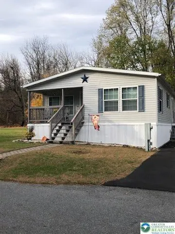 a white house that has a tree in front of it
