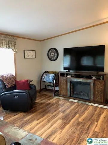 a view of a livingroom with furniture and a flat screen tv
