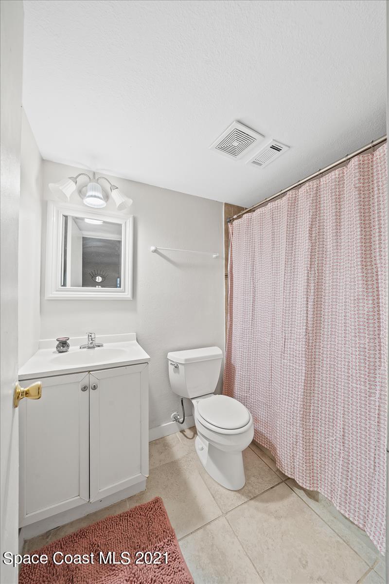 151 Ulster Lane Melbourne, FL 32935 - Photo 11 of 14 a bathroom with a toilet sink and mirror