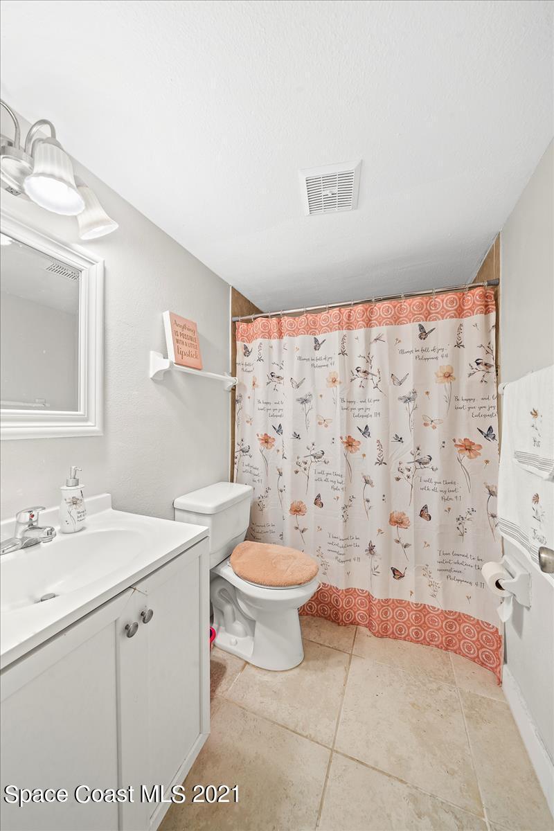 151 Ulster Lane Melbourne, FL 32935 - Photo 14 of 14 a bathroom with a sink toilet and shower