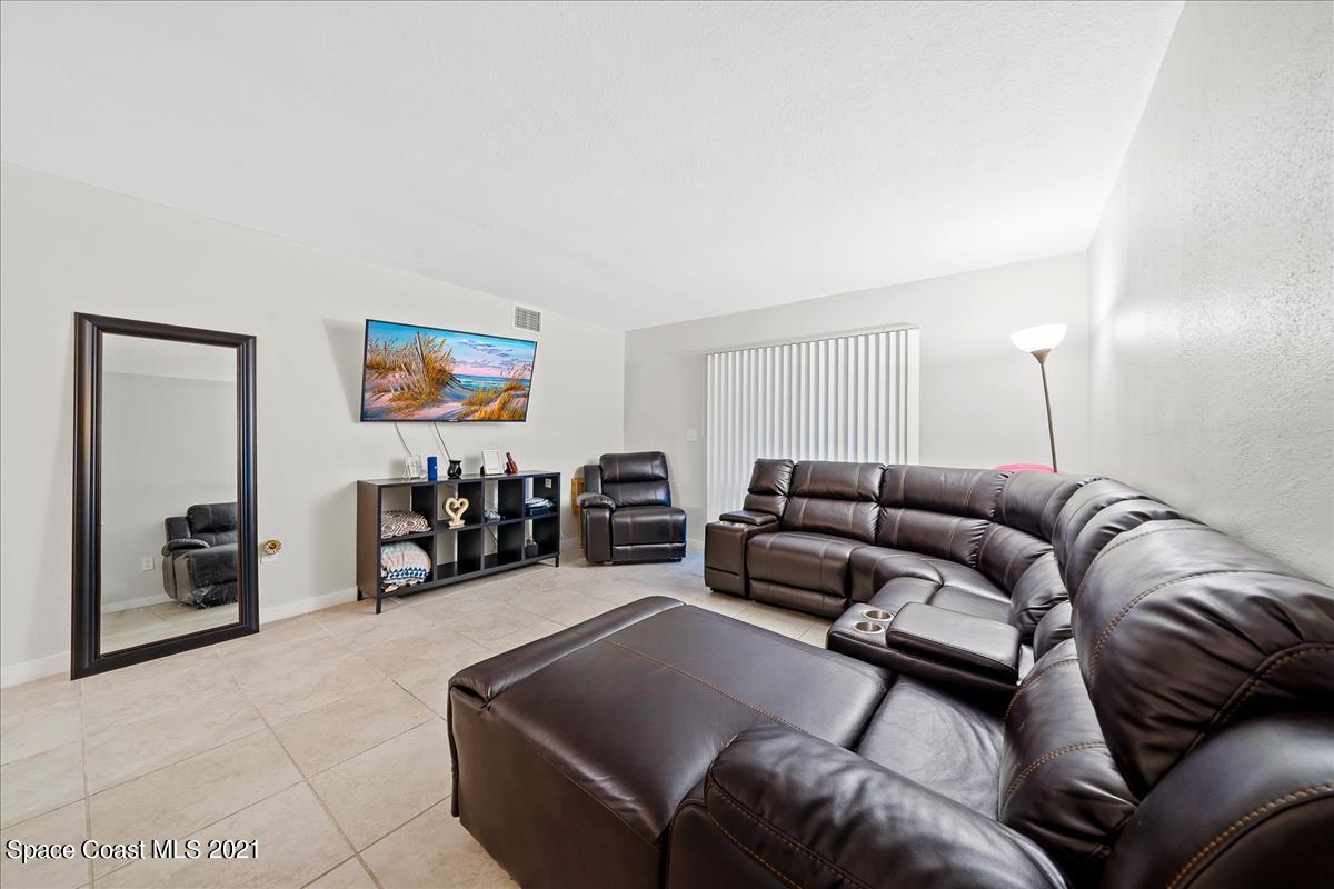151 Ulster Lane Melbourne, FL 32935 - Photo 2 of 14 a living room with furniture and a flat screen tv
