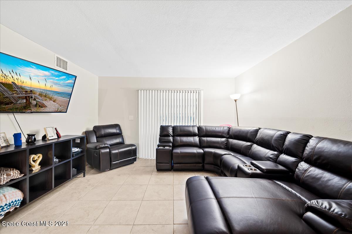 151 Ulster Lane Melbourne, FL 32935 - Photo 3 of 14 a living room with furniture and a flat screen tv