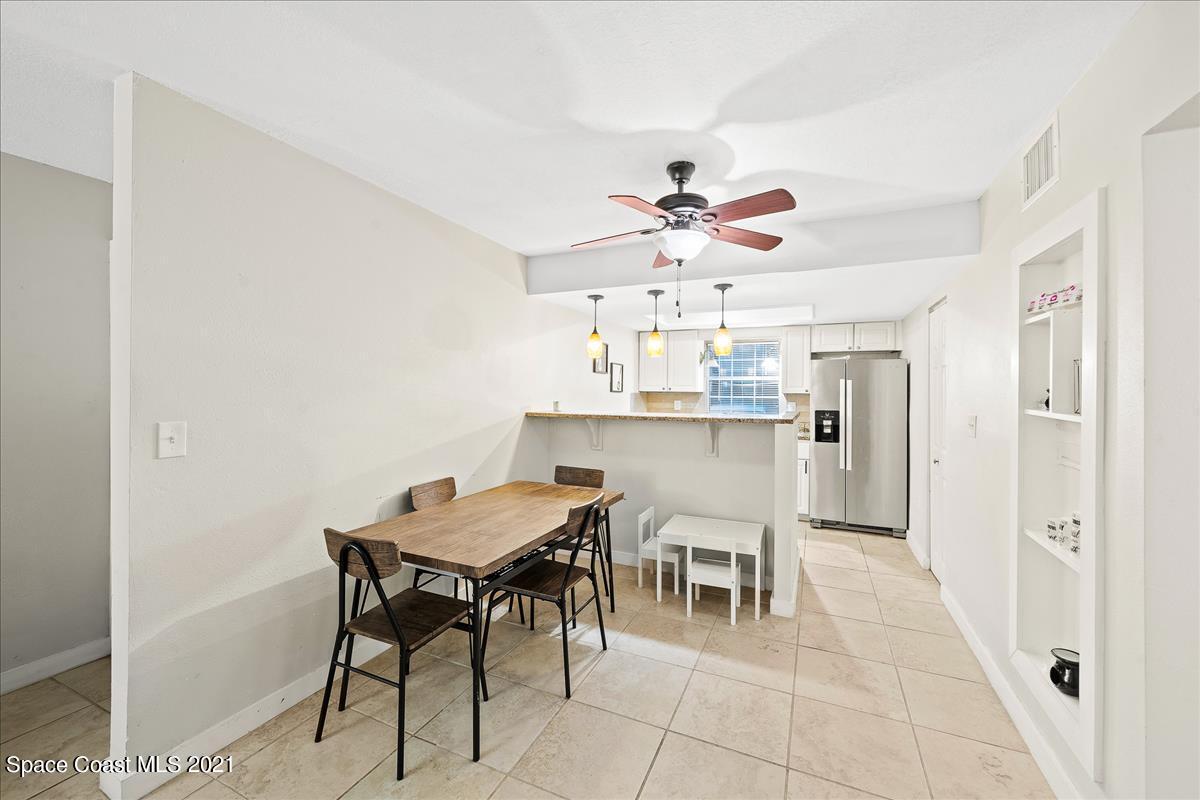 151 Ulster Lane Melbourne, FL 32935 - Photo 4 of 14 a view of a dining room with furniture and chandelier
