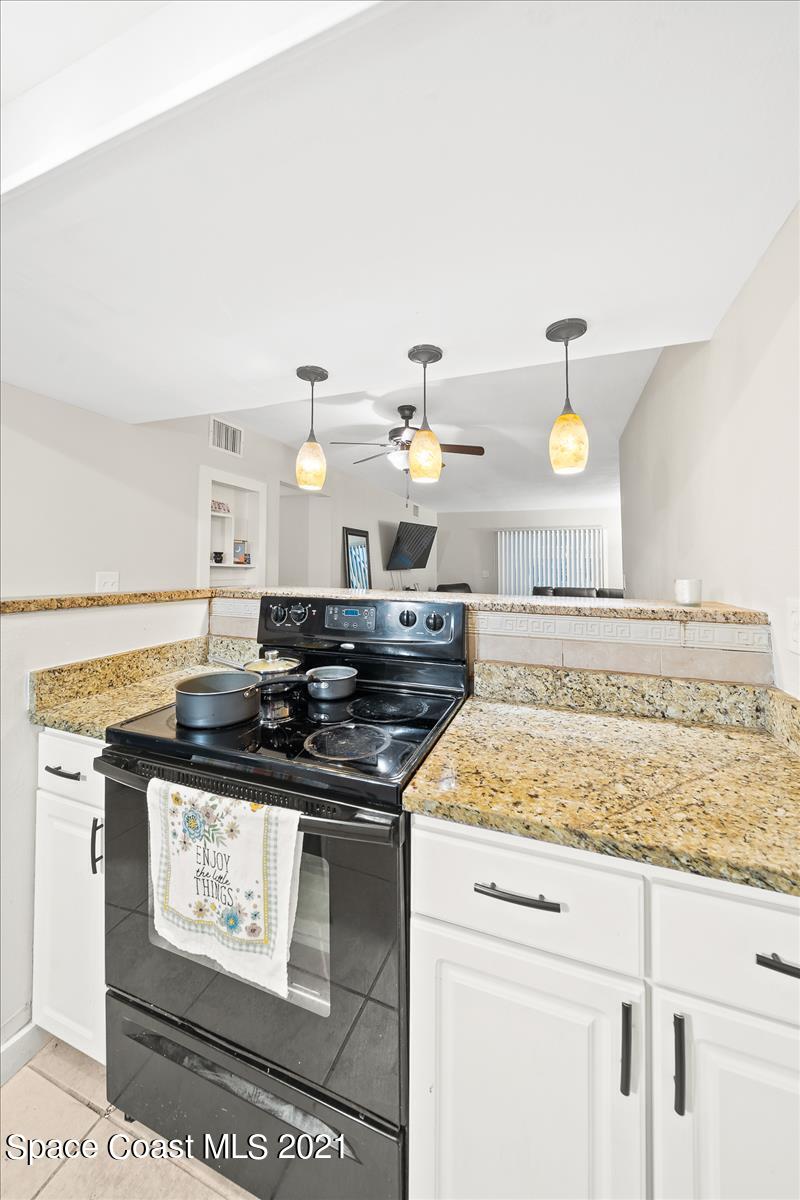 151 Ulster Lane Melbourne, FL 32935 - Photo 5 of 14 a kitchen with a stove and cabinets