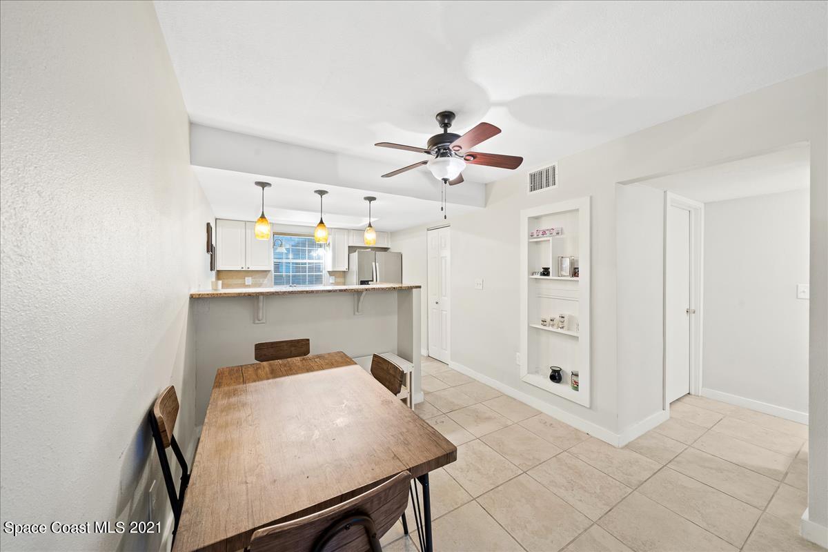 151 Ulster Lane Melbourne, FL 32935 - Photo 8 of 14 a view of a kitchen and a dining room with furniture