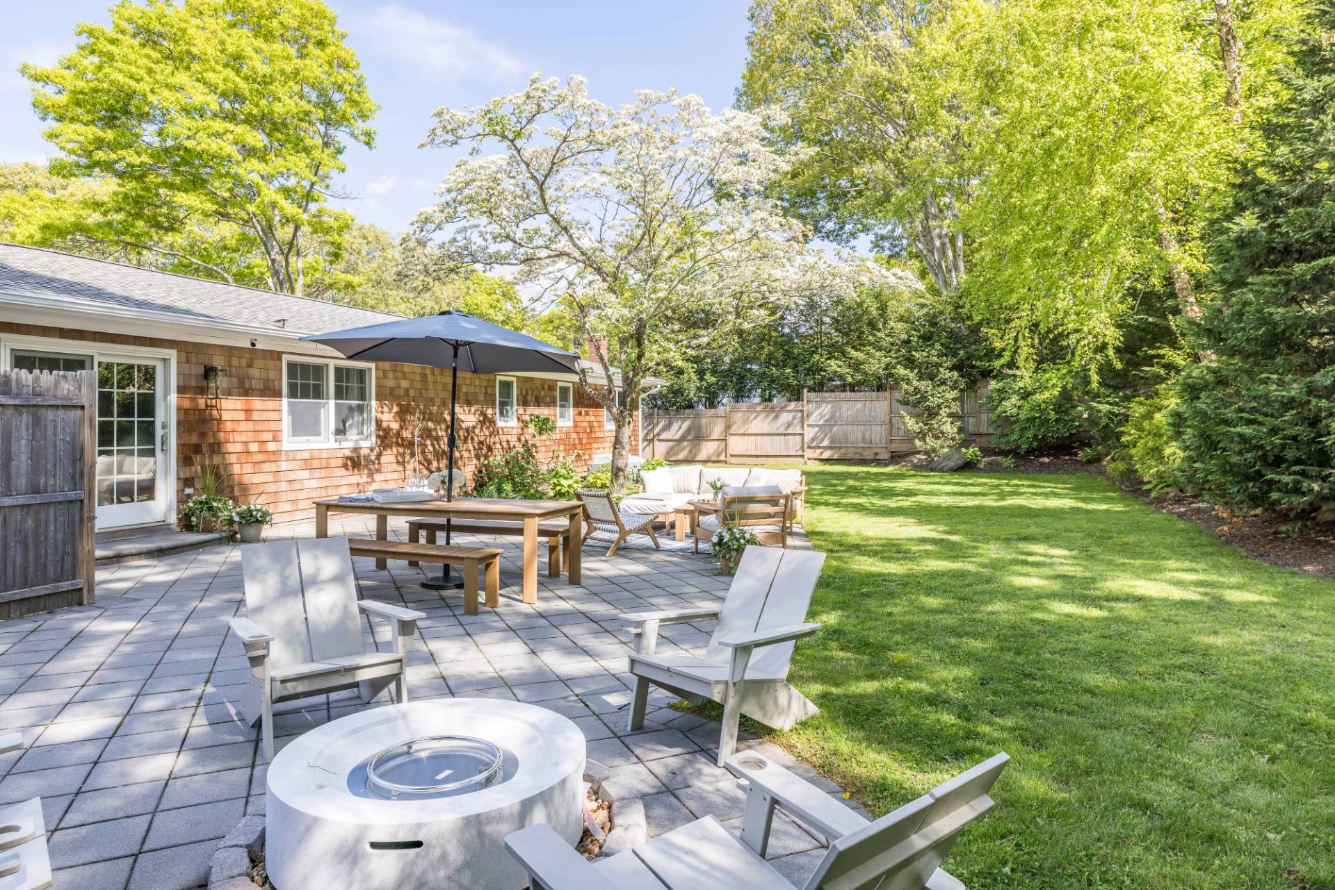 40 Ridge Road West Sag Harbor, NY 11963 - Photo 4 of 27 a view of a patio with table and chairs potted plants and large tree