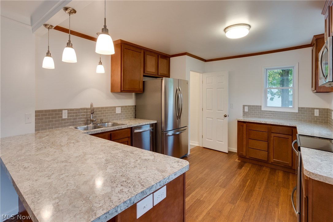 38705 Chardon Road Willoughby Hills, OH 44094 - Photo 8 of 35 The overall effect of the kitchen is just stupendous - crown molding - new doors - clean, new baseboard moldings - neutral counters in a complementing pattern to match subway tile backsplash