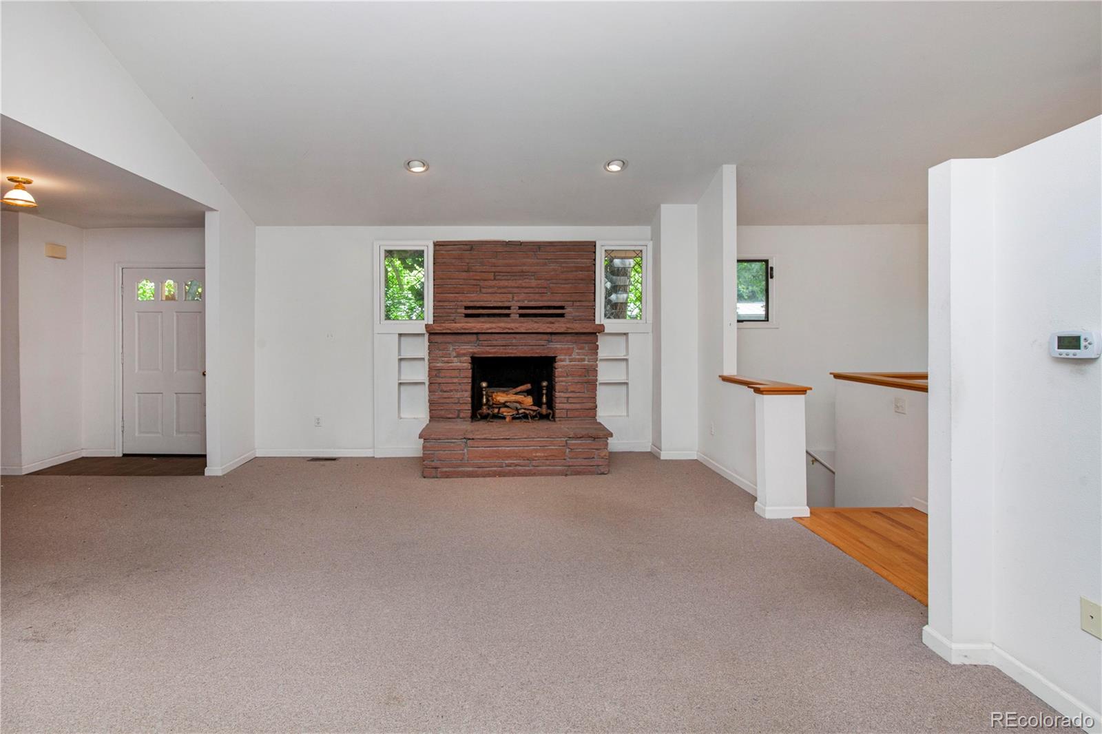 609 Pleasant Street Boulder, CO 80302 - Photo 13 of 28 an empty room with furniture and a fireplace