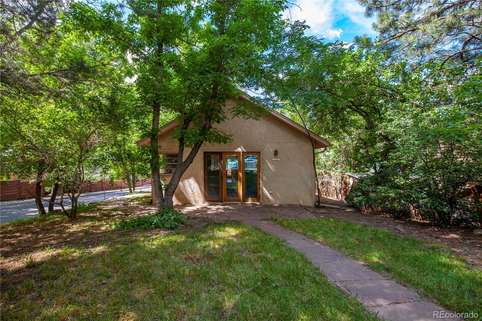 609 Pleasant Street Boulder, CO 80302 - Photo 2 of 28 a view of a house with backyard and a tree