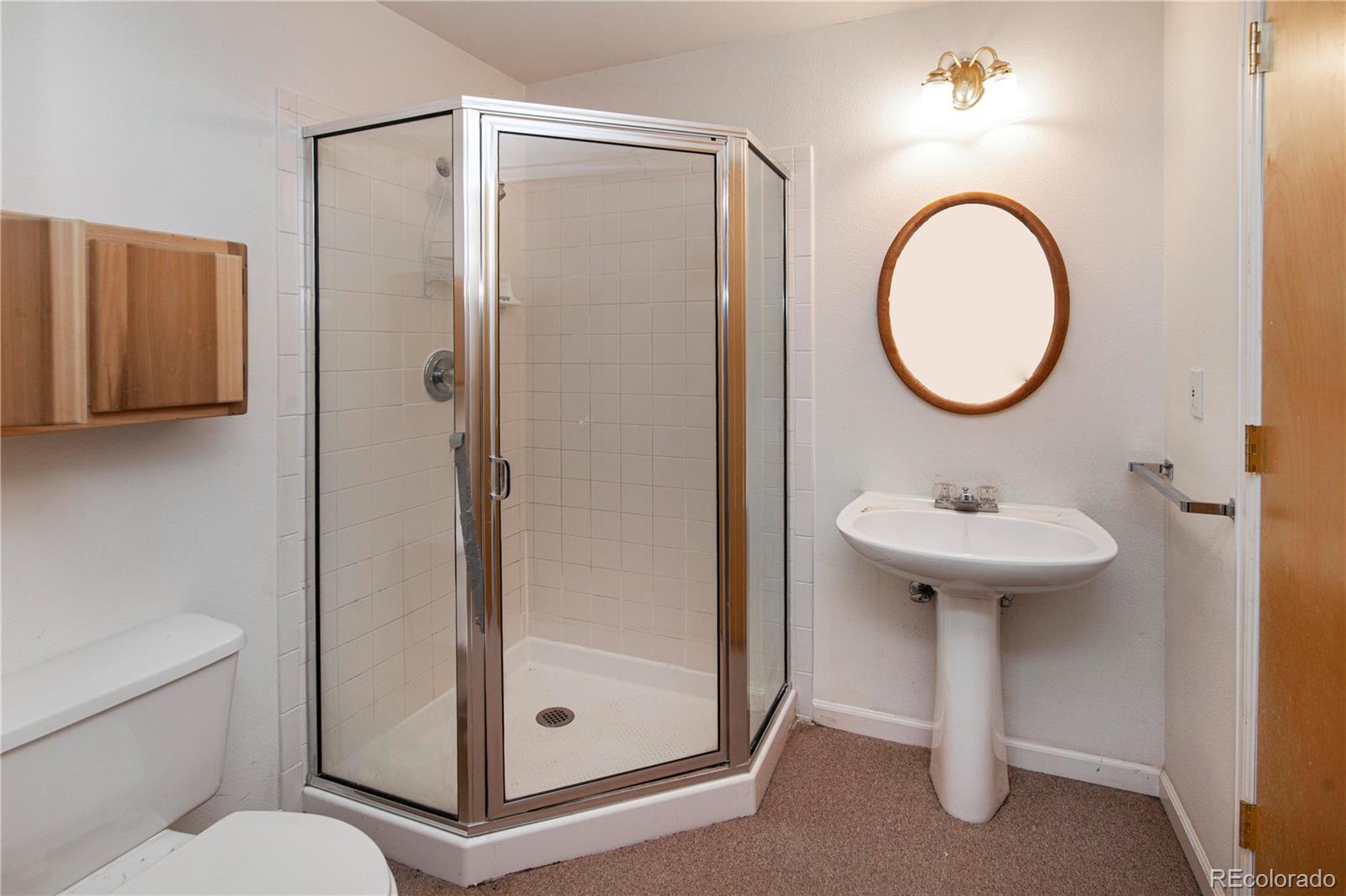 609 Pleasant Street Boulder, CO 80302 - Photo 21 of 28 a bathroom with a sink a toilet and a mirror
