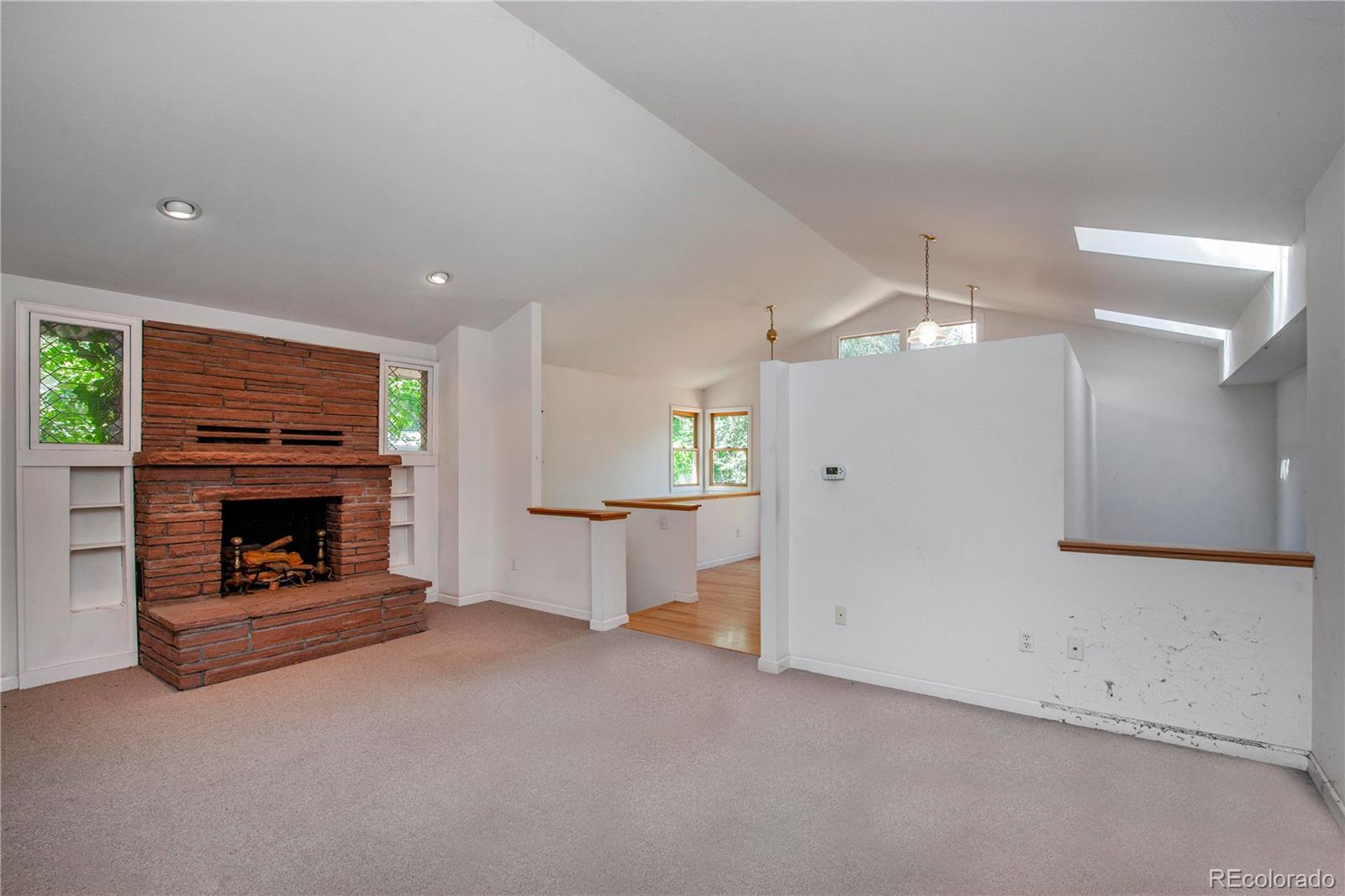 609 Pleasant Street Boulder, CO 80302 - Photo 7 of 28 an empty room with fireplace and window