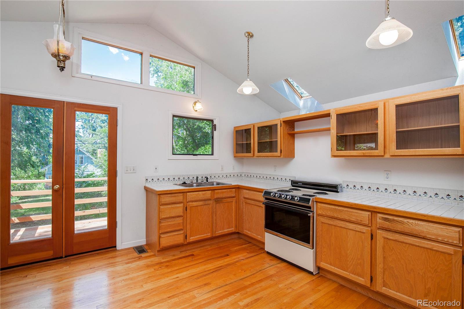 609 Pleasant Street Boulder, CO 80302 - Photo 10 of 28 a kitchen with stainless steel appliances granite countertop stove a sink and a refrigerator