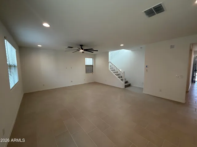 an empty room with a empty space and windows