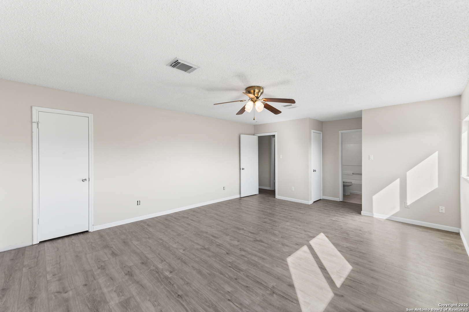8010 Chestnut Gate Drive Converse, TX 78109 - Photo 23 of 37 a view of empty room with wooden floor and ceiling fan