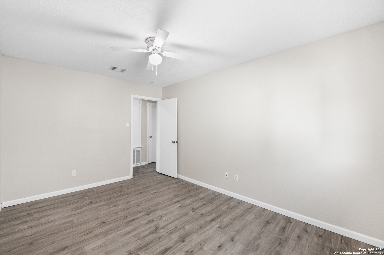 8010 Chestnut Gate Drive Converse, TX 78109 - Photo 28 of 37 a view of an empty room with wooden floor