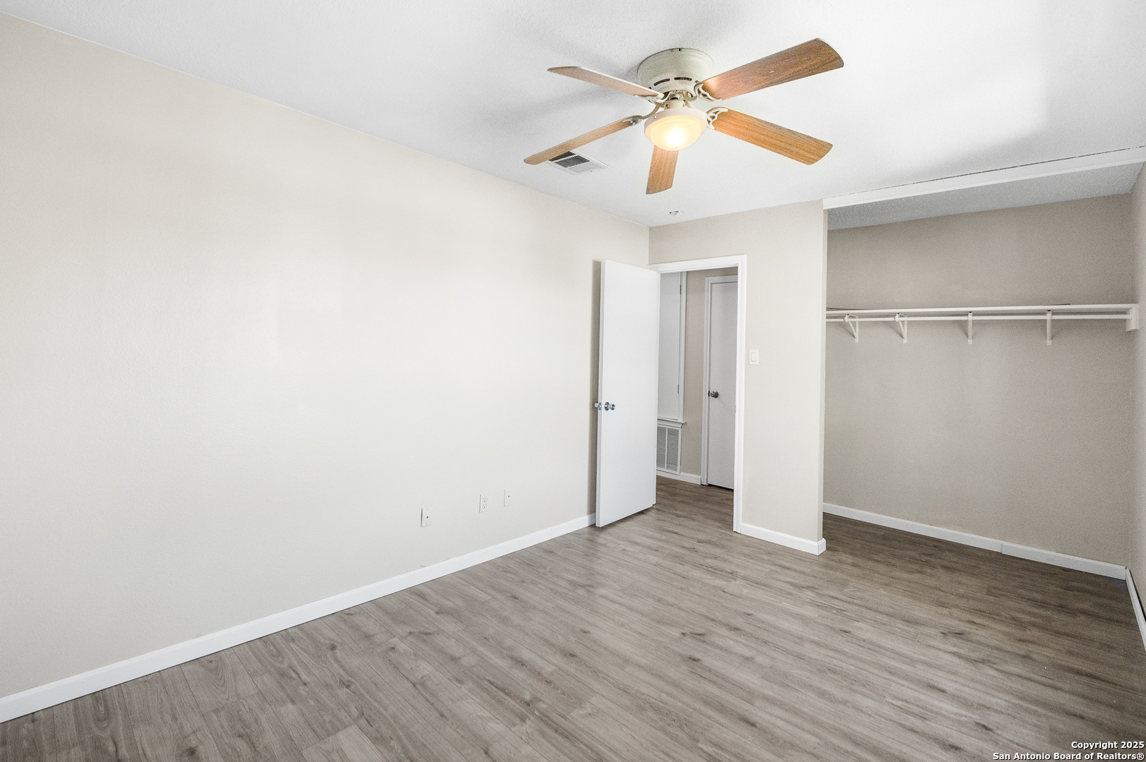 8010 Chestnut Gate Drive Converse, TX 78109 - Photo 31 of 37 an empty room with wooden floor ceiling fan