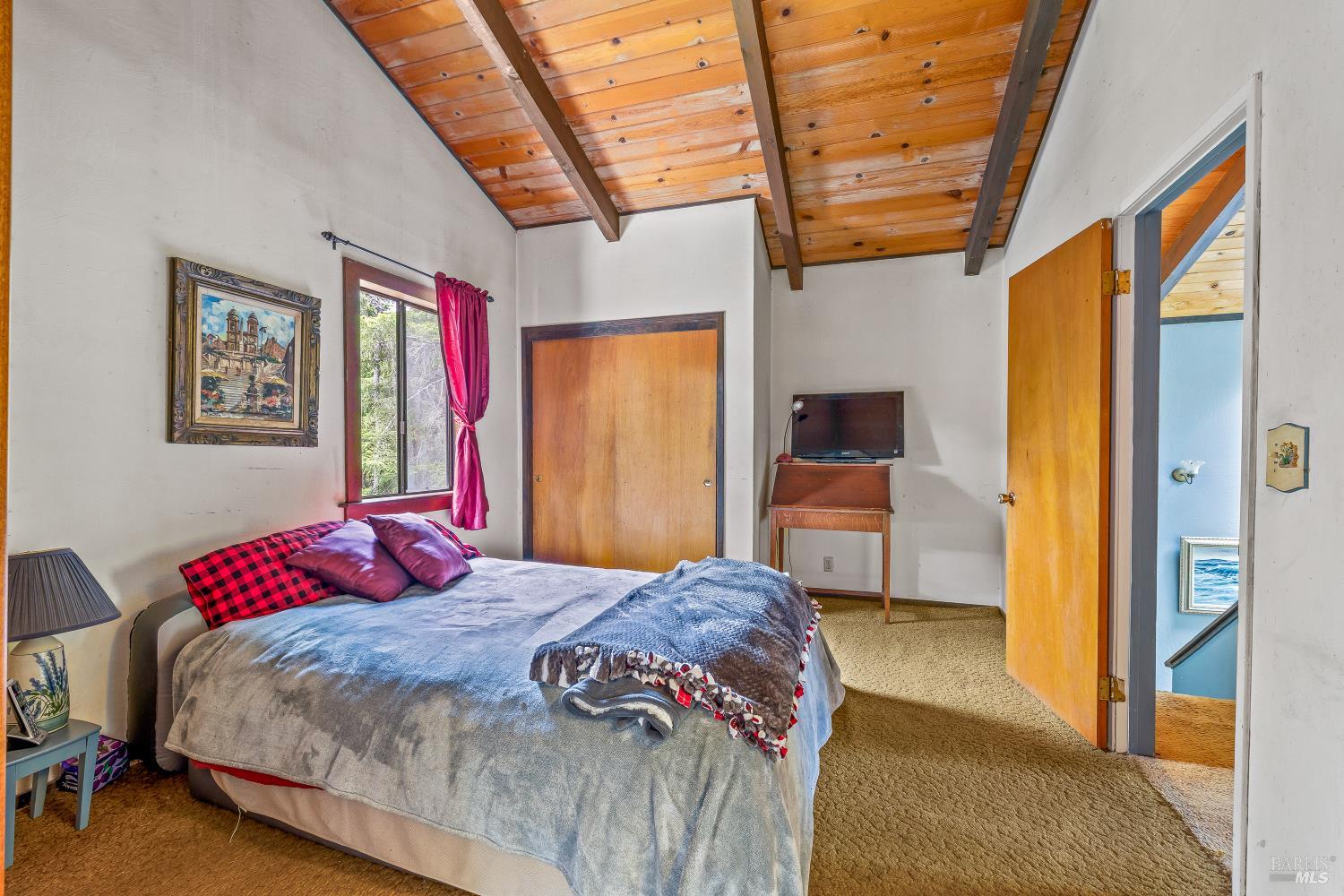 43150 Little Lake Road Mendocino, CA 95460 - Photo 14 of 27 a bedroom with a bed a dresser next to a window