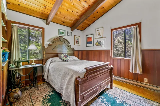 a bed sitting in a bedroom next to a window