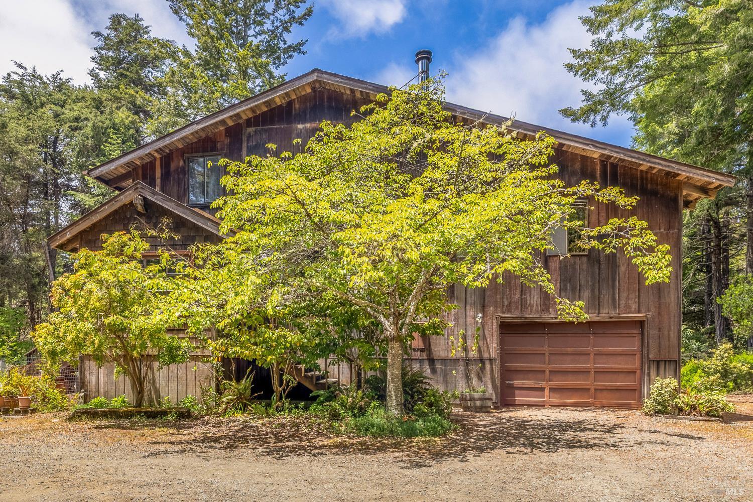 43150 Little Lake Road Mendocino, CA 95460 - Photo 2 of 27 a front view of a house with a tree