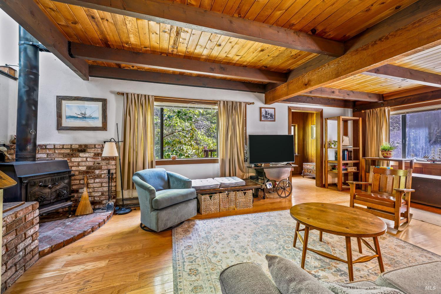 43150 Little Lake Road Mendocino, CA 95460 - Photo 3 of 27 a living room with furniture and a flat screen tv