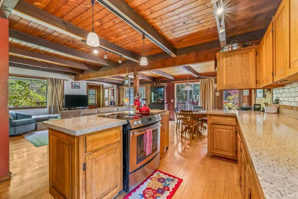 a open kitchen with stainless steel appliances granite countertop a stove and a refrigerator