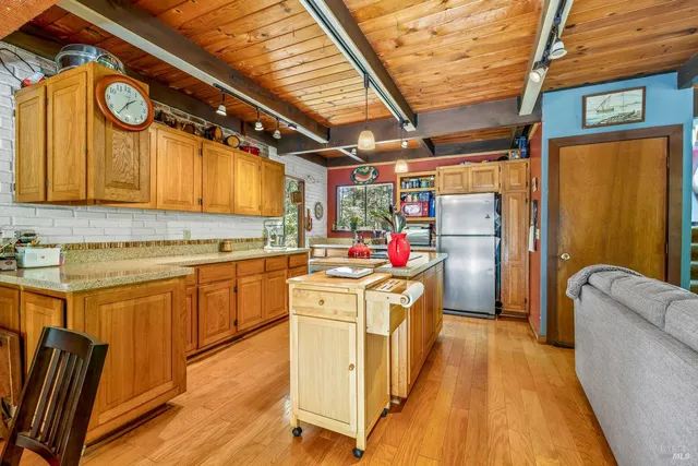 a kitchen with a stove and a refrigerator