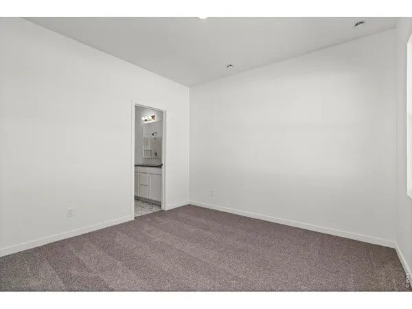 a bathroom with a sink a toilet a large mirror and shower