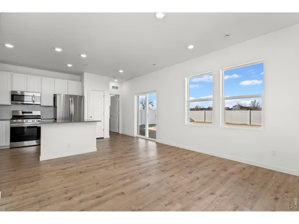 a kitchen with stainless steel appliances a refrigerator stove and microwave