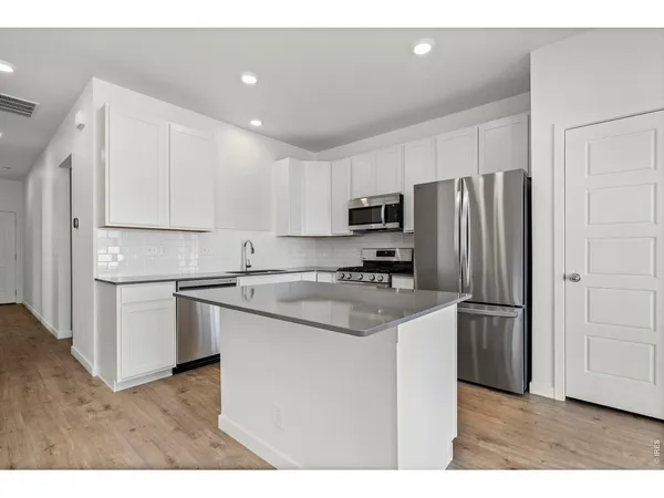 a kitchen with granite countertop a sink and cabinets