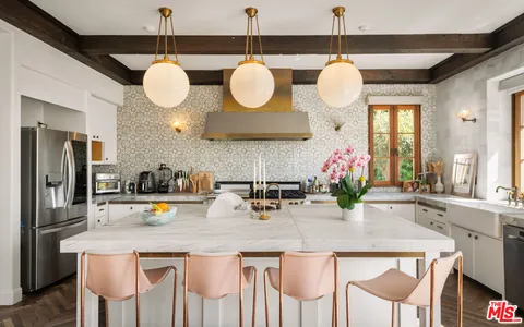 a kitchen with a table and chairs in it