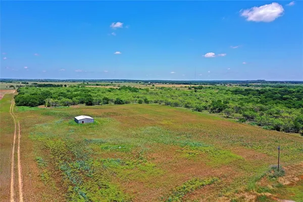a view of a green field with clear sky