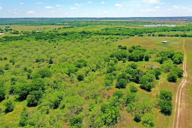 an aerial view of a houses with a yard