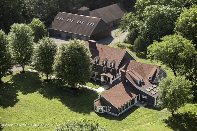 an aerial view of a house with garden space and street view