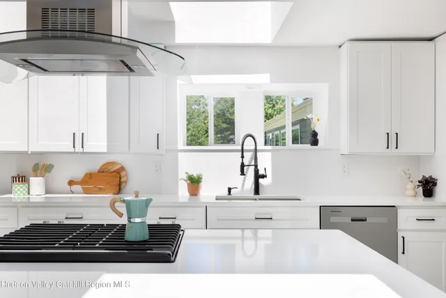 a kitchen with a stove a refrigerator and a window