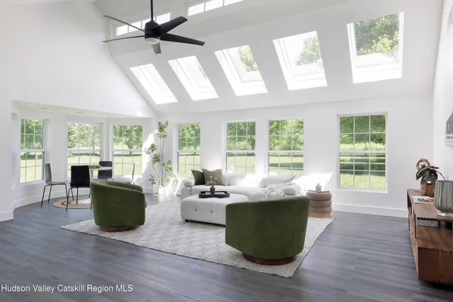 a living room with furniture and large windows