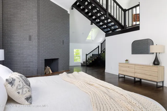 a bedroom with a bed window and a chair