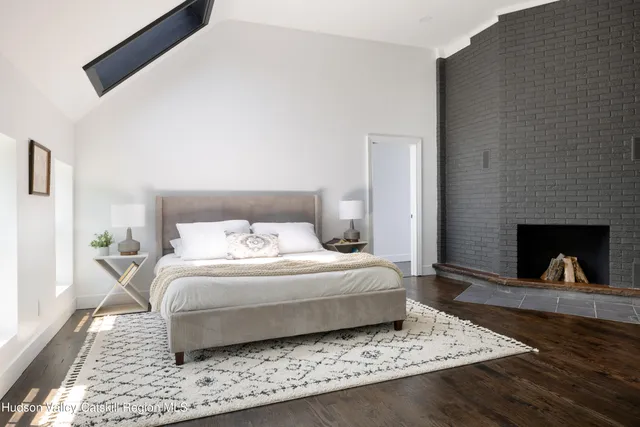 a bedroom with a bed and a fireplace