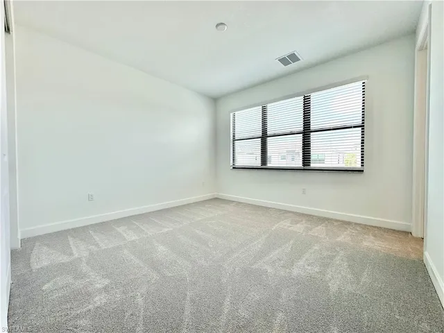 an empty room with a empty space and window